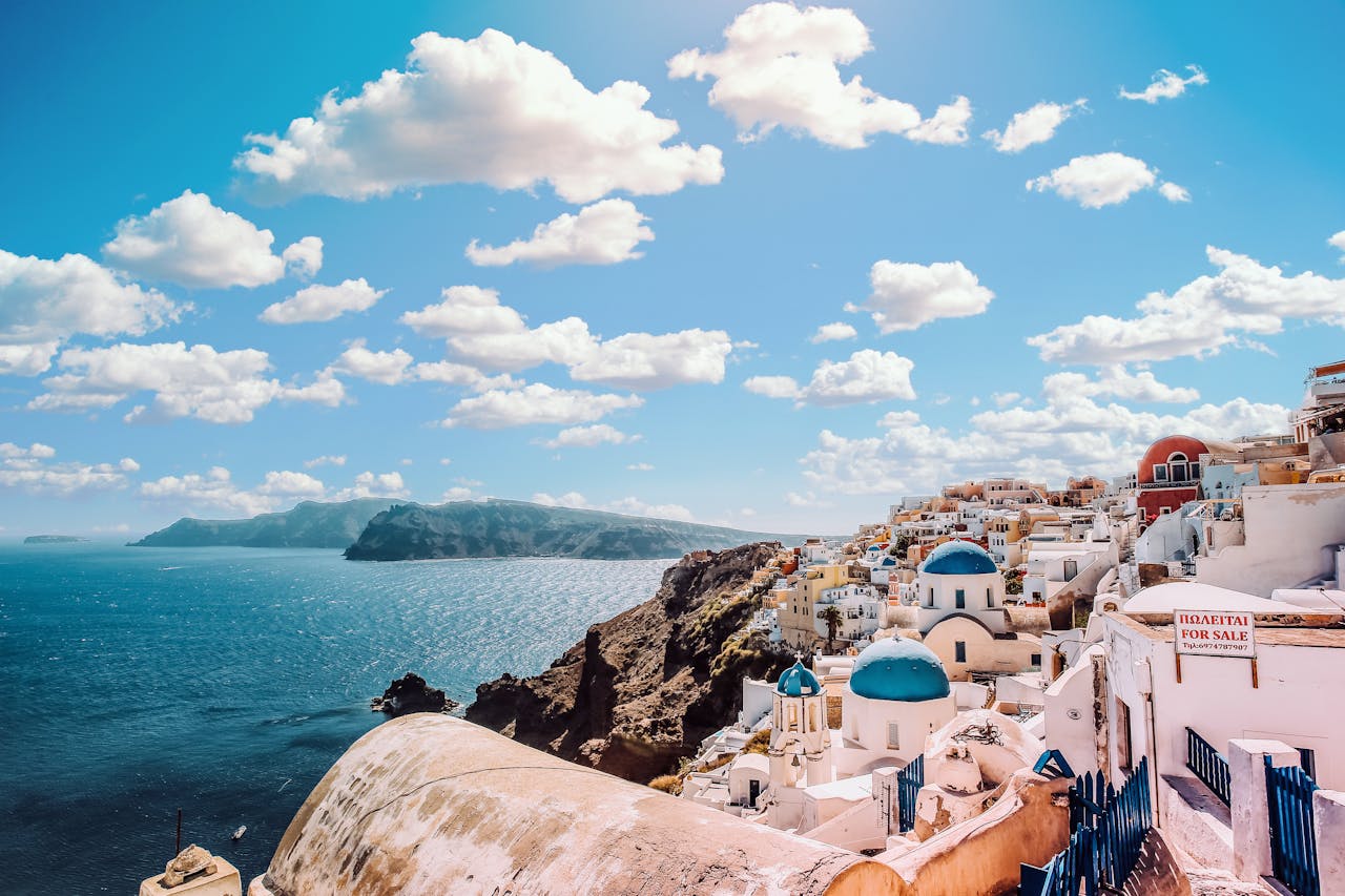 Captivating view of Santorinis famous blue-domed buildings under a vibrant sky.